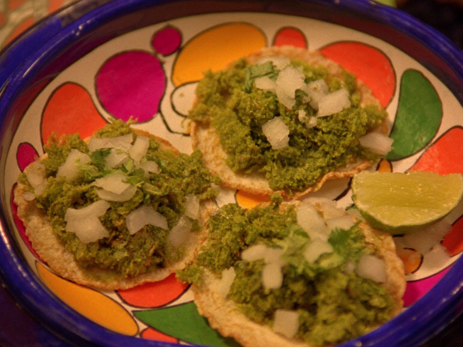 Three green chorizo tacos on corn tortillas