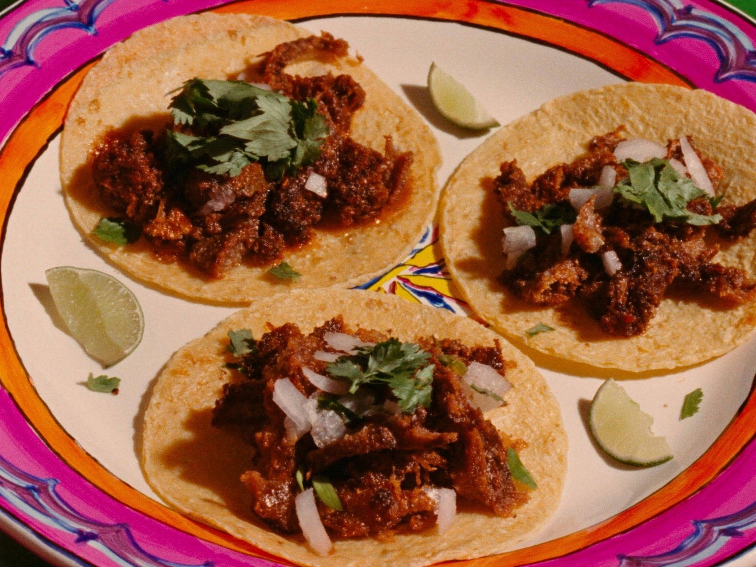 Three suadero beef tacos with onion and cilantro