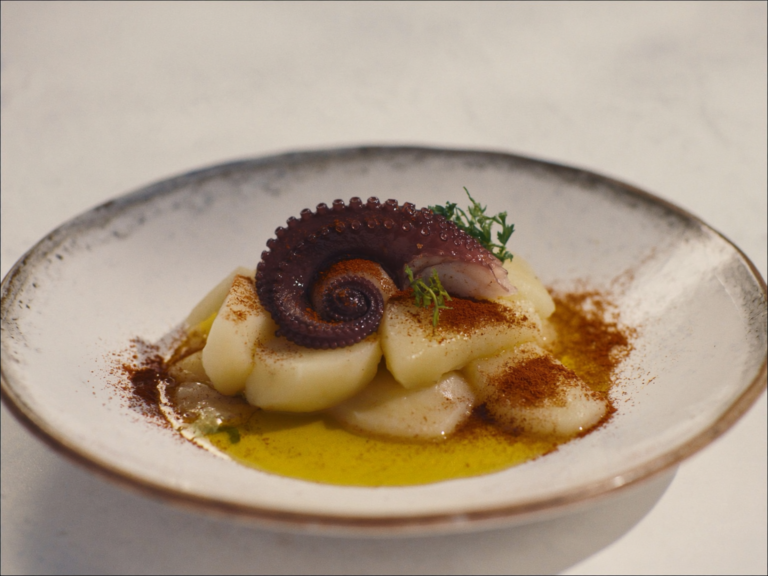 Octopus with confit potato and smoked paprika oil